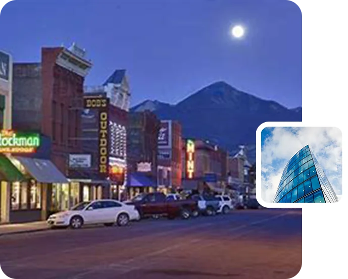 A street with cars parked on the side of it and a building in the background.