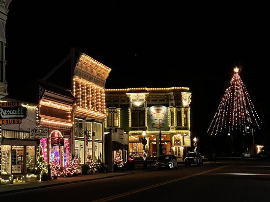 A street with many lights on the buildings