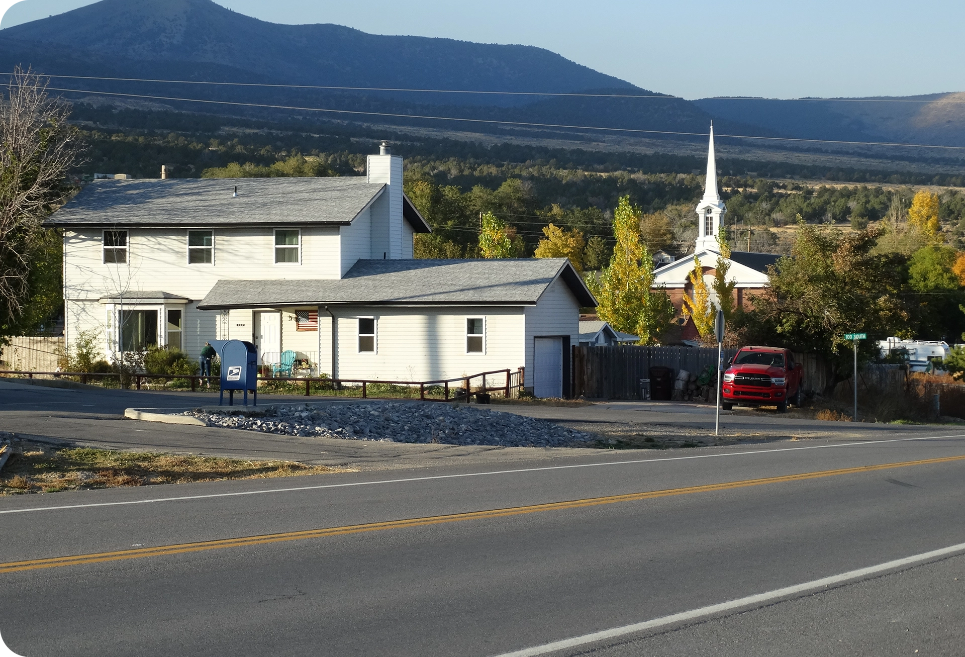 A white house sitting next to a road.