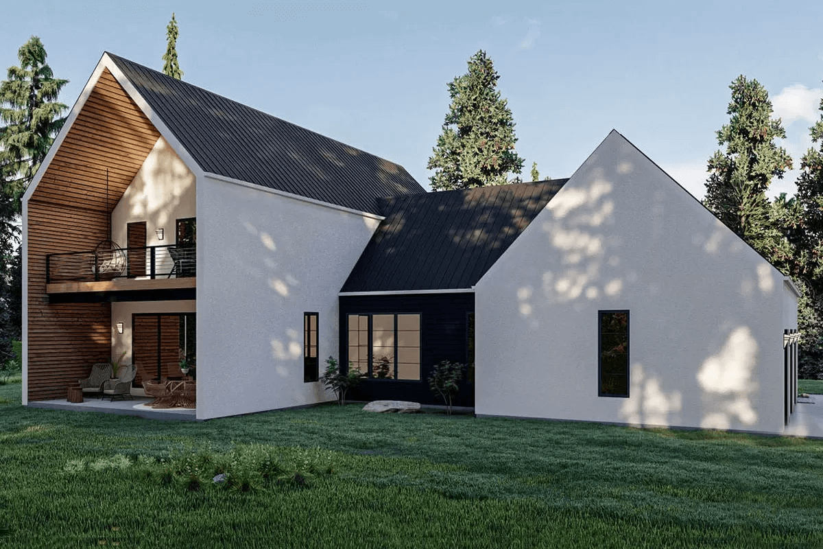 A white house with black trim and a large lawn.