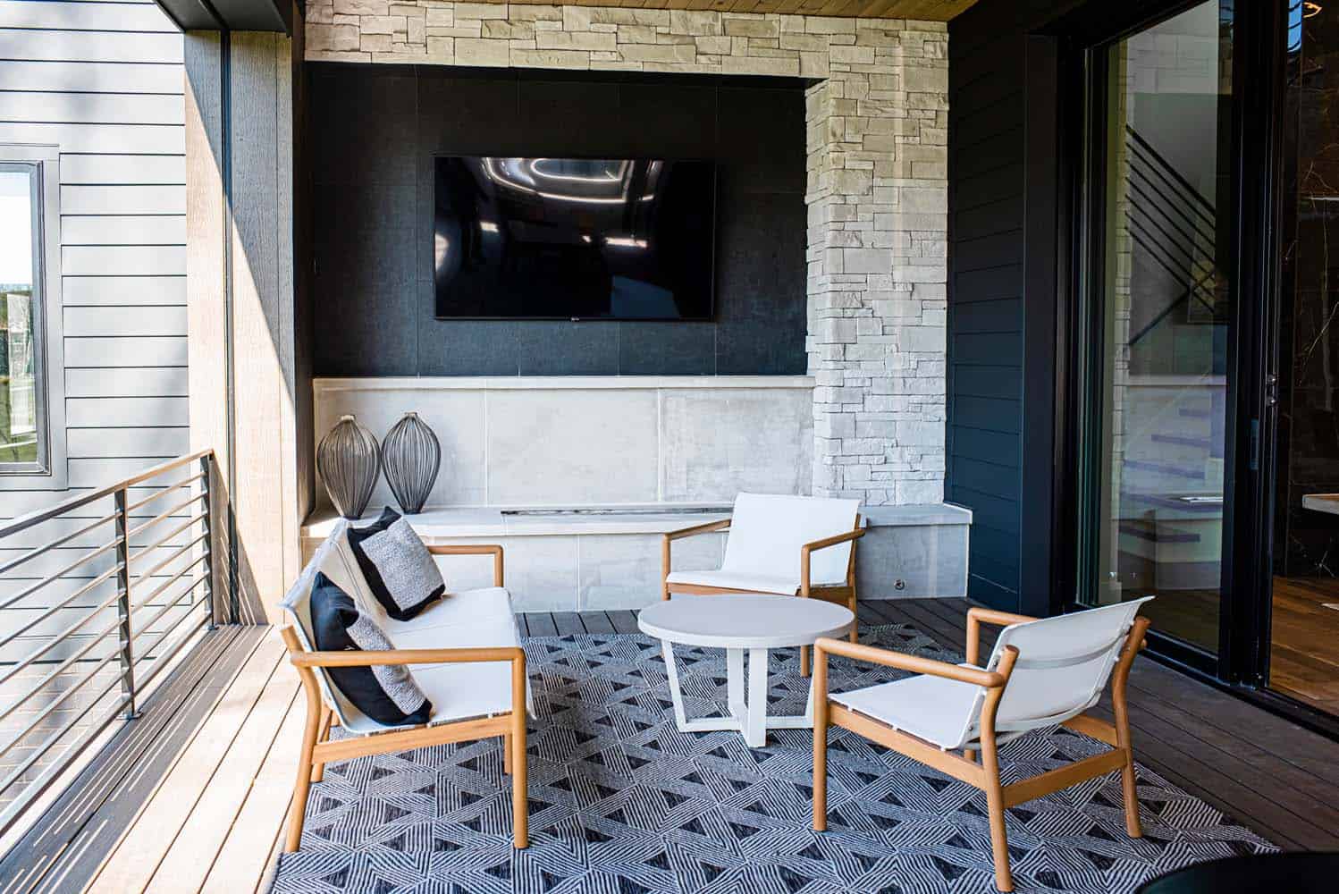 A patio with chairs and tables on the ground