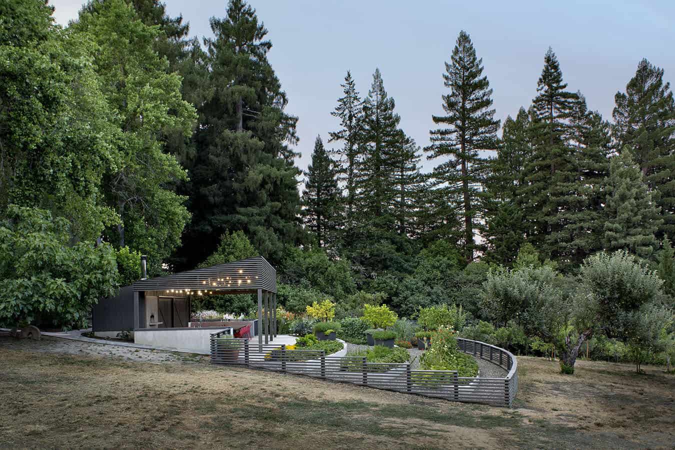 A gazebo in the middle of a forest with trees.