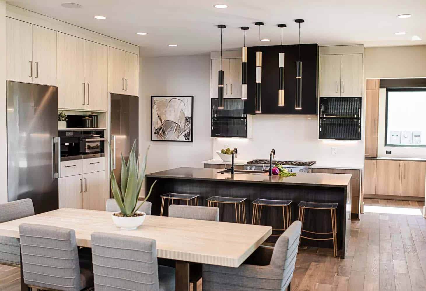 A kitchen with a dining table and chairs