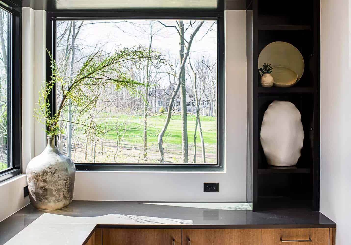 A window with a view of the trees outside.