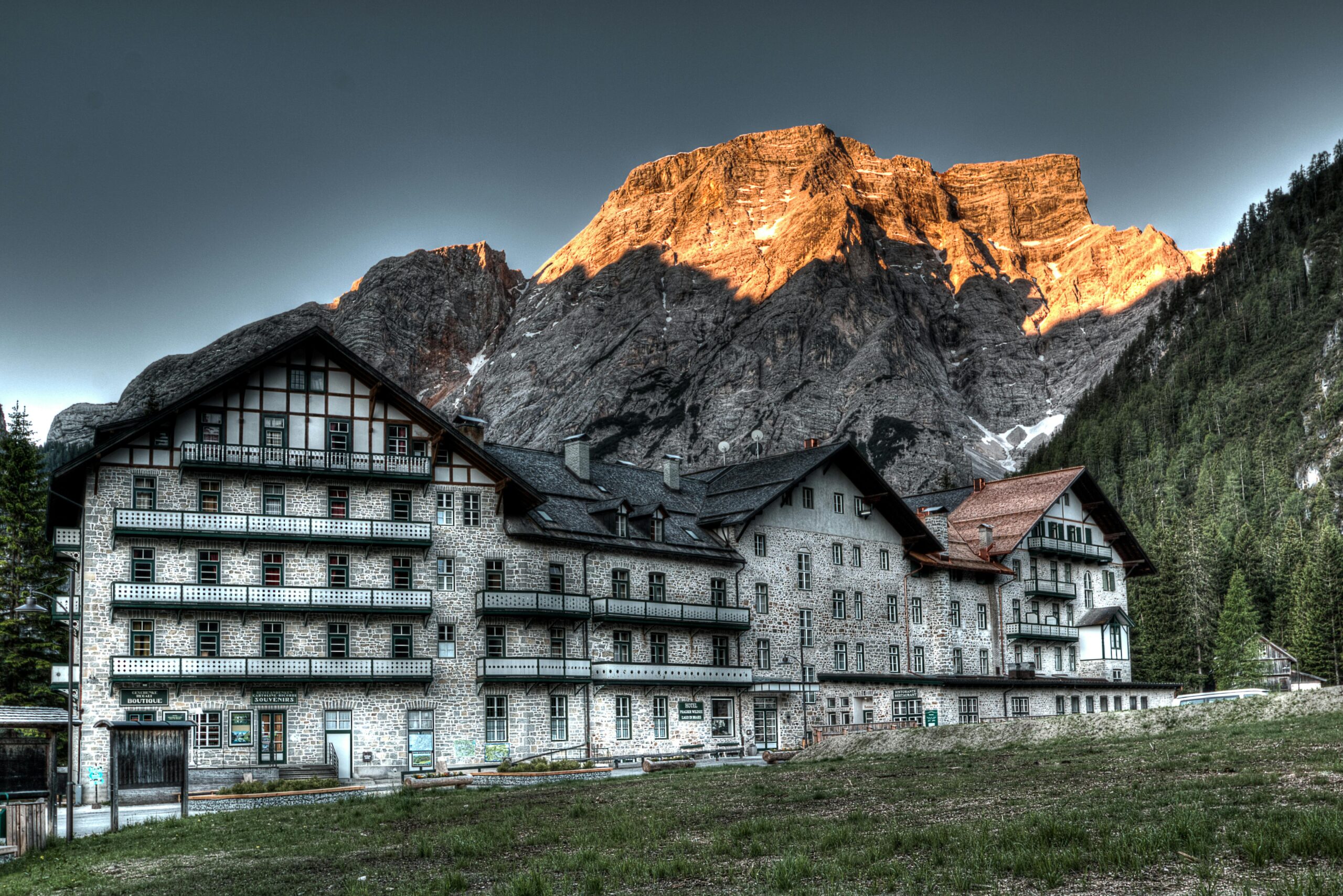 A mountain view of some buildings and grass