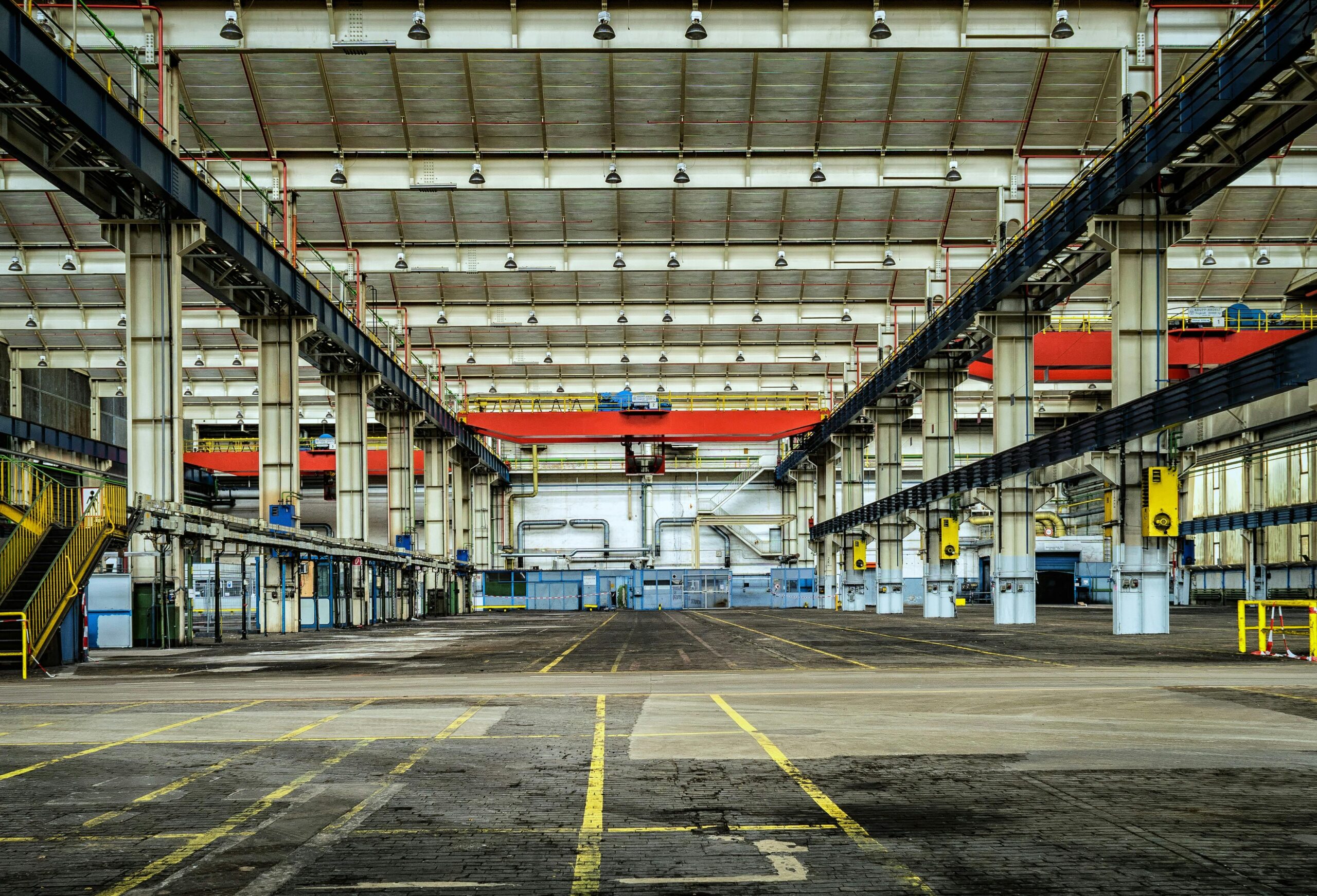 A large warehouse with many floors and overhead cranes.