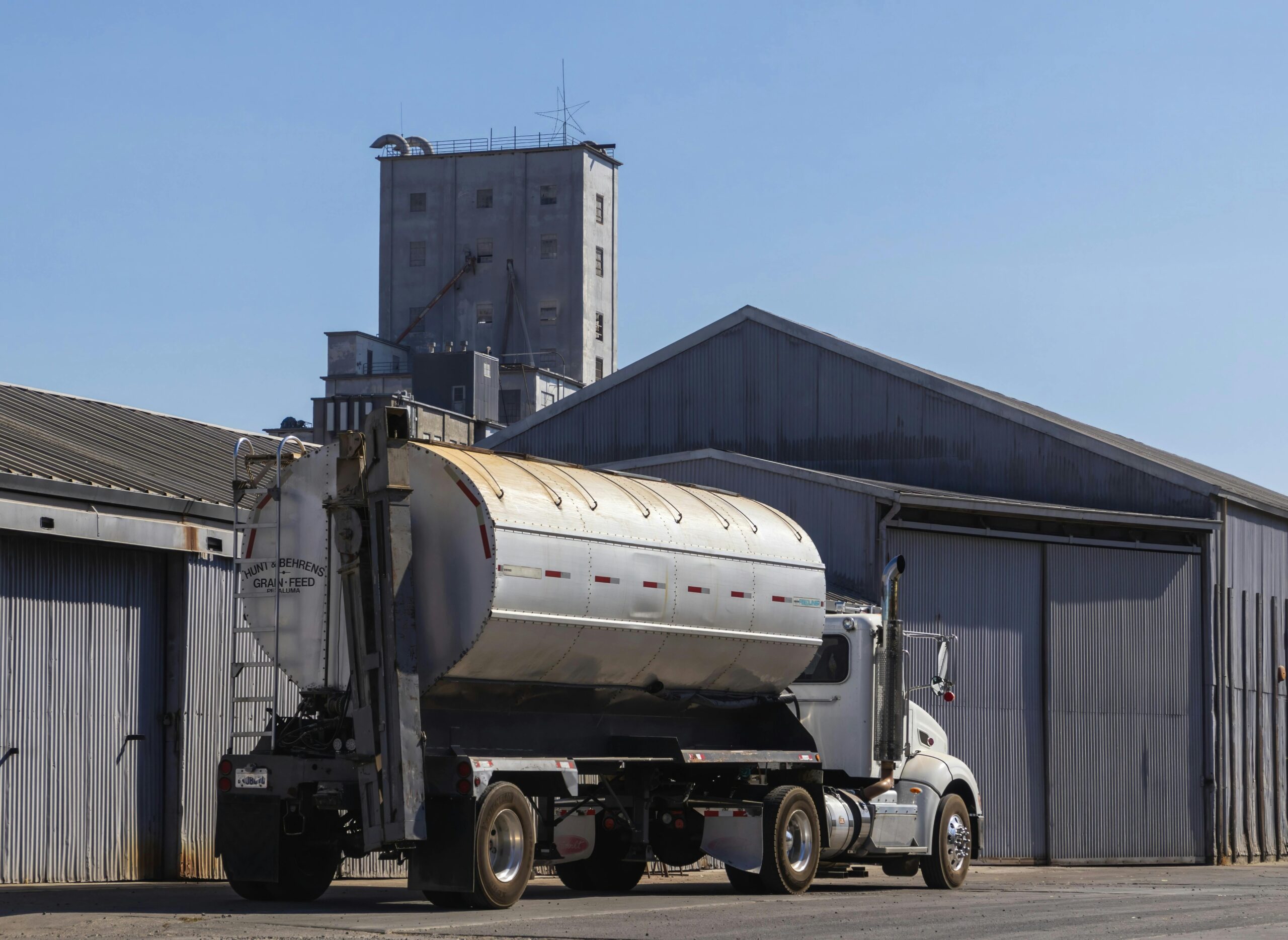 A large truck parked in front of a building.